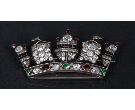 An unusual diamond, ruby and emerald maritime crown brooch, ornamented with central Galleon stern, between unfurled sails and