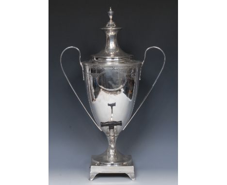 A George III Neo-Classical silver tea urn, lofty cover with vasular finial, bright-cut engraved, with stiff leaves and pendan