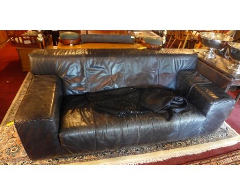 A 20th century black leather two seater sofa raised on chrome feet. 