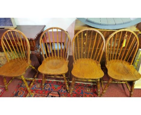 A set of four 20trh century oak stick back dining chairs 