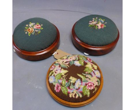 A pair of Victorian burr walnut stools with floral tapestry upholstery raised on ceramic bun feet together with one other sto