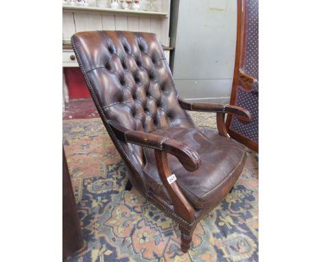 Button-back brown leather armchair