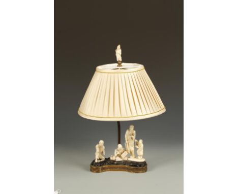 THREE JAPANESE IVORY FIGURE GROUPS, one of a scholar writing, mounted as a table lamp, 18" high, Meiji.  Provenance: Private 