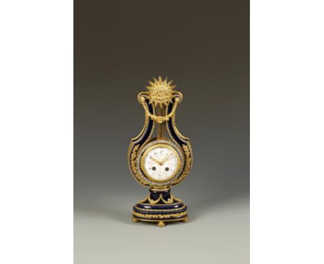 A FRENCH CERAMIC AND ORMOLU MANTEL CLOCK with circular enamel dial signed "Kinable, Paris", with eight day two train movement