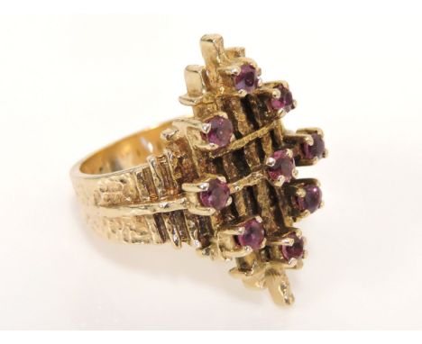 A 9ct gold ruby dispersed cluster ring, with a bark textured head and shoulders, London 1979, 9.2g
