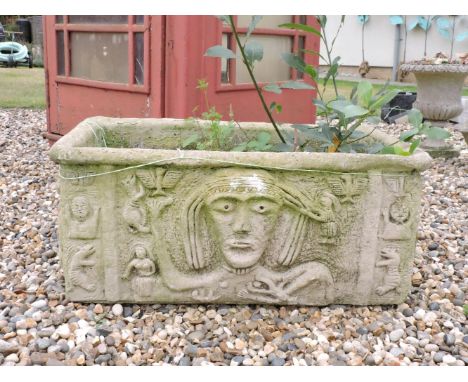 A rectangular composite planter, with tribal decoration, 77cm wide, 35cm tall, a small composite stone campana urn, 45cm tall