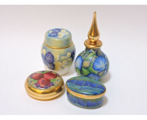 Four pieces of Moorcroft enamel wares, comprising an oval patch box, paperweight, scent bottle and cover, and a miniature gin