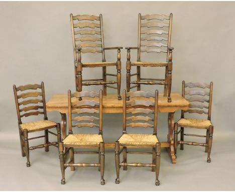 An oak refectory dining table, and six ladder back chairs with rush seats, table 169 x 76cm