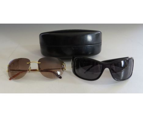 A pair of Cartier vintage sunglasses, with tinted lenses, and signed 'Cartier' to frames, together with a pair of Roberto Cav