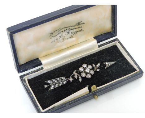 A Victorian diamond floral cluster and arrow brooch, set in silver and backed in gold, tested as approximately 15ct gold and 