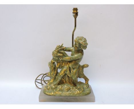 A modern composite table lamp, in the form of a boy wrestling a goat, 50cm tall