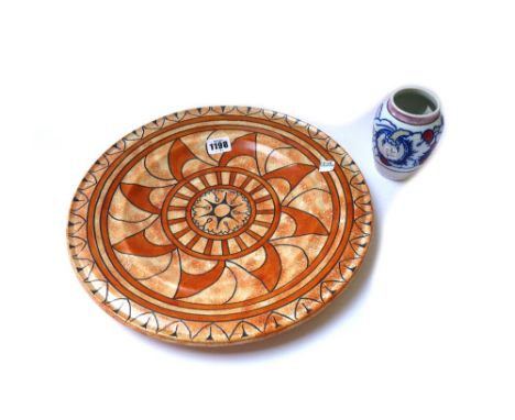 A Burleigh Ware charger designed by Charlotte Rhead, tube lined and decoated with the `Florentine' pattern, 4752, in shades o