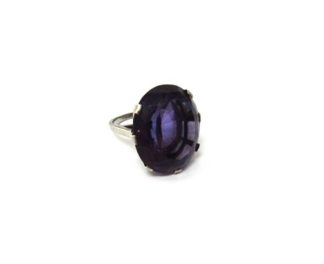 An amethyst set single stone ring, claw set with an oval cut amethyst, ring size K and a half.