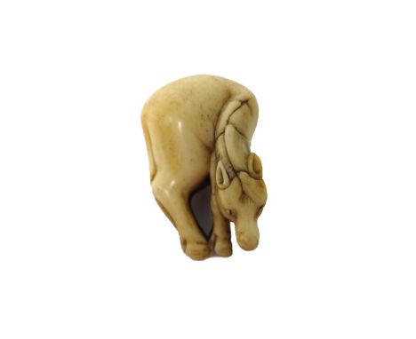 A Japanese marine ivory netsuke of a grazing horse, 19th century, 5cm.high. 