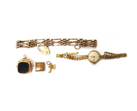 A gold bar and oval link gate bracelet, with a gold heart shaped padlock clasp, weight 16.5 gms, a rotating pendant fob, glaz