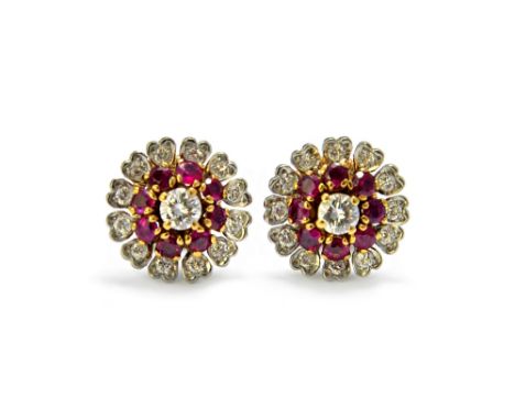 A pair of ruby and diamond set cluster earstuds, each claw set with the principal circular cut diamond at the centre, in a su