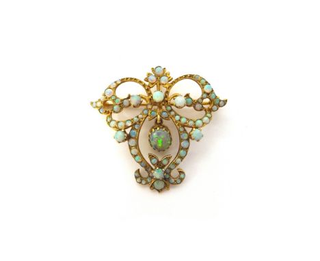 A gold and opal set pendant brooch, in a scroll pierced openwork design, mounted with the principal oval opal to the centre a