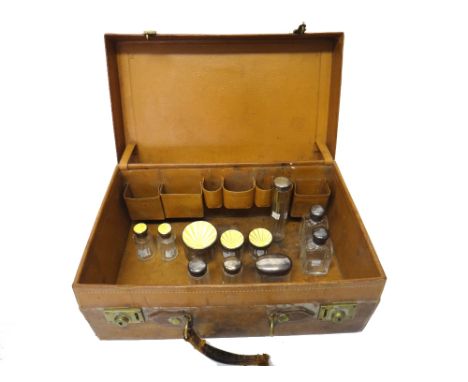 Five silver and yellow enamel lidded, faceted glass toilet bottles and jars, mostly London 1936, a silver lidded, faceted gla