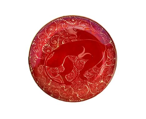 A good ruby lustre earthenware dish attributed to William De Morgan, late 19th century, painted with a prowling lioness again