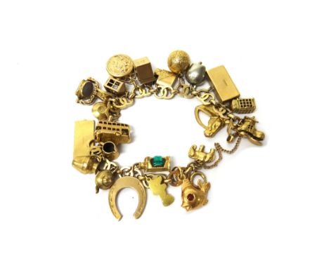 A 9ct gold charm bracelet, in a twin circular link design, fitted with a variety of mostly 9ct gold pendants and charms, incl