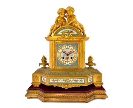 A French ormolu and porcelain mounted mantel clock, late 19th century, with twin cherub surmount over a porcelain dial plate 