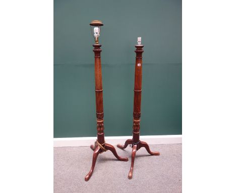 A pair of 19th century and later mahogany standard lamps, with carved semi fluted columns on a tripod base, together with a 1