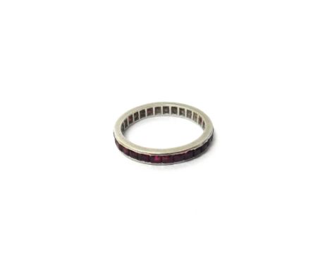 A Boucheron ruby set full eternity ring, mounted with square cut rubies, the side of the setting detailed Boucheron, ring siz