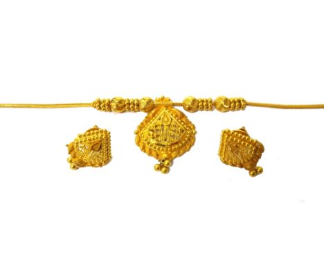 A gold necklace and a matching pair of gold earstuds, each in a beaded and pierced panel shaped design, the necklace with a w