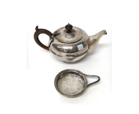 A George III silver strainer, of circular form, London 1792, weight 76.5 gms and a plated teapot of circular form, engraved w