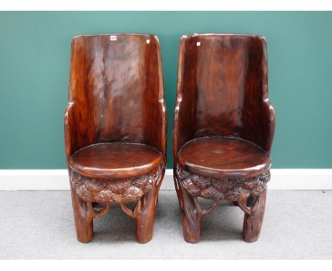 A pair of 20th century Eastern carved hardwood trunk chairs, the backs depicting elephants in the jungle, (2).