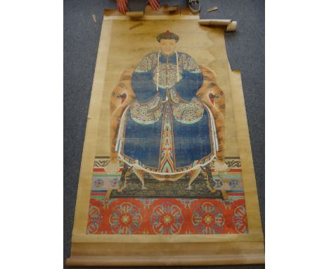 A large Chinese ancestor portrait scroll on silk, laid onto paper,  painted with an official wearing blue robes with dragon r