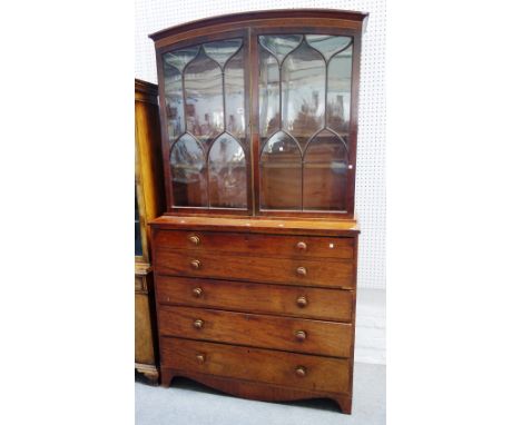 A George III mahogany secretaire bookcase, the arch top with Gothic astragal glazed doors, over fitted drawer and three furth