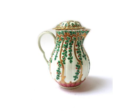 A Worcester porcelain pear shaped milk jug and cover, circa 1770, painted with hops and berries above a pink chevron border, 