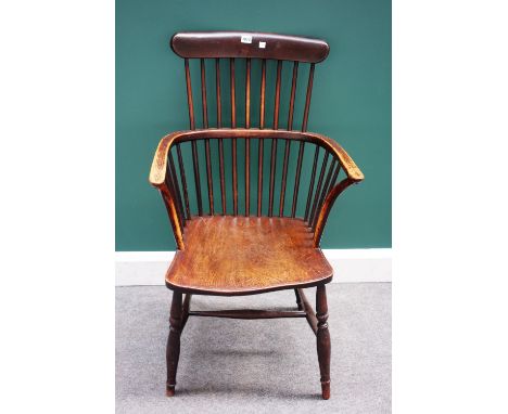 An early 19th century ash and elm comb back Windsor chair, on turned supports.