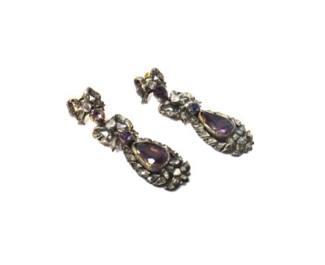 A pair of diamond and foil backed amethyst set pendant earrings, each with an oval drop centred by a pear shaped amethyst and