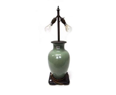 A Chinese celadon baluster vase, moulded with dragons and tendrils beneath a ruyi border, 38cm.high, adapted as a lamp with w