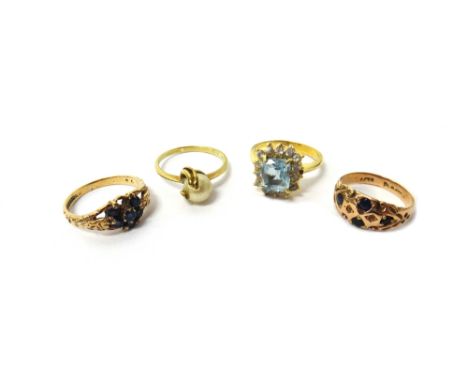 A gold, aquamarine and colourless gem set cluster ring, detailed 18 K, two 9ct gold and sapphire set rings and another ring, 