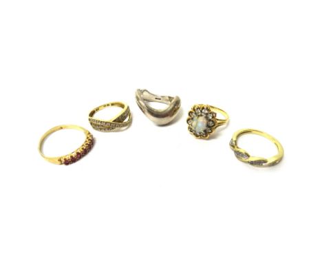 A 9ct gold and diamond set ring, in a three row twistover design, a 9ct gold and diamond set ring, in an undulating design, a