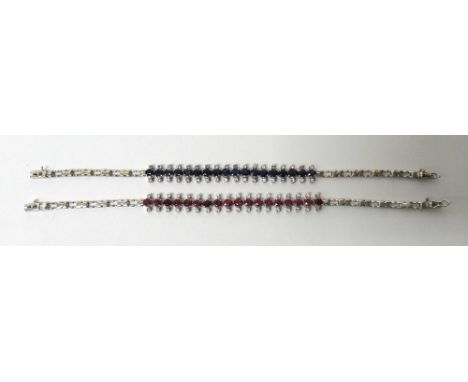 A ruby and colourless gem set bracelet, mounted with a row of cushion shaped rubies to the centre and with pairs of small cir