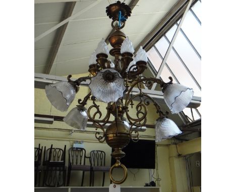 A Victorian twelve branch brass chandelier, the shaped baluster stem issuing twelve lights over two graduated tiers, the top 