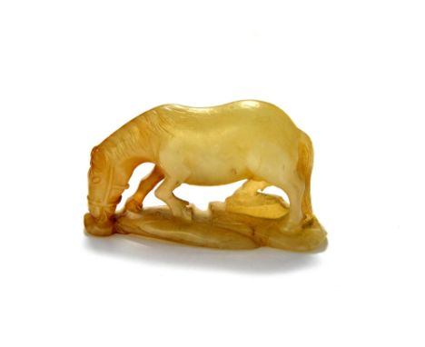 A Chinese grey and russet jade figure of a horse, Qing Dynasty, 18th/19th century, carved standing four square with head lowe