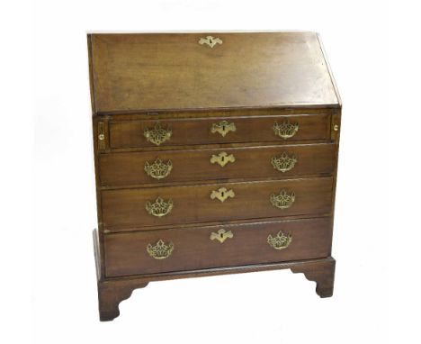 Georgian mahogany bureau, the fall front enclosing a stepped fitted interior, over four graduated long drawers upon bracket f