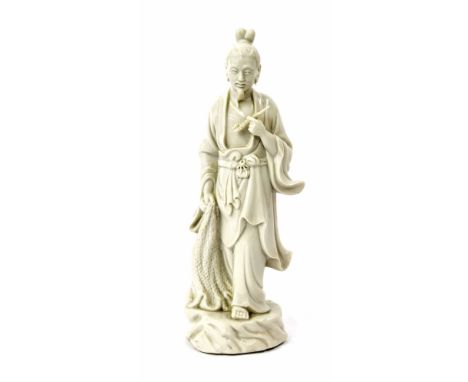 Chinese blanc de chine figure of a gentleman carrying a pipe and a fishing net, 11" high