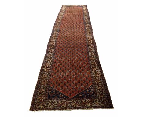 Persian carpet runner, on red ground with multiple geometric and foliate borders, 182" x 43"