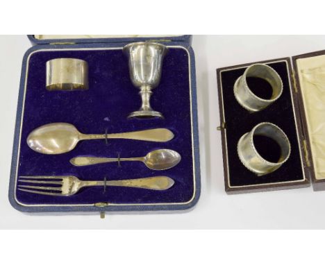 Cased silver christening set comprising a napkin ring, egg cup, two spoons and a fork, each piece monogrammed 'W', maker Wake