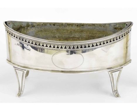 Neo-classic style oval boat shaped planter, with a pierced bright-cut decorated rim upon four slender tapered feet, with line