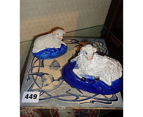 Two Staffordshire sheep and an Art Nouveau blue and white tile