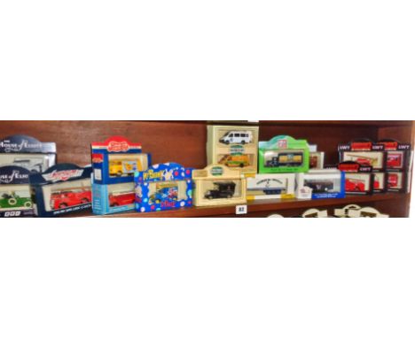 Shelf of boxed Lledo diecast branded vehicles, inc. Mr. Blobby!