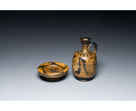 Full title: An Etruskian 'aryballos' portrait ewer and a 'patera' dish with black geometrical design, 4th C. b.C.Description: