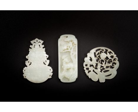 Full title: Three Chinese celadon and white jade pendants, QingDescription:L.: 8 cm (the largest pendant)Condition reports:Co